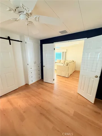 a bedroom with a bed and a mirror