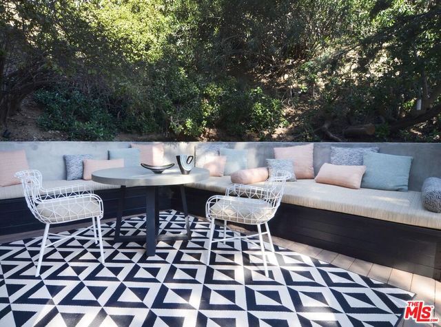 a view of a patio with couple of chairs