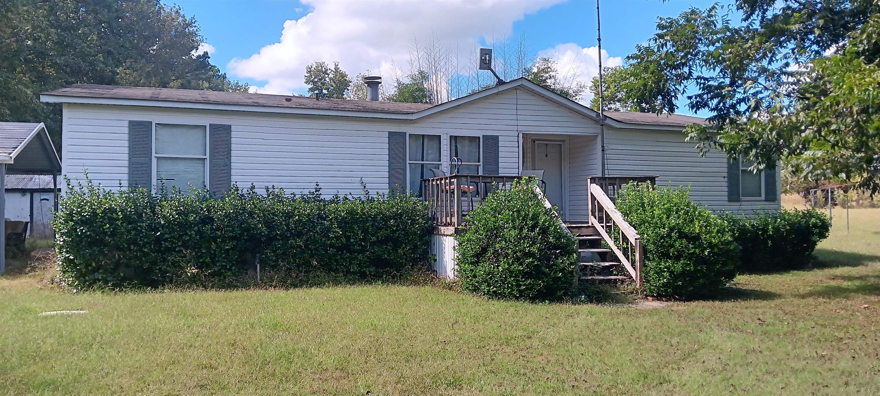 Back of property with a lawn