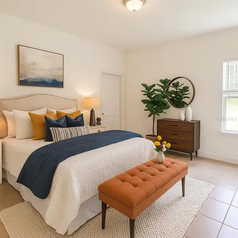 a bedroom with a bed and a potted plant