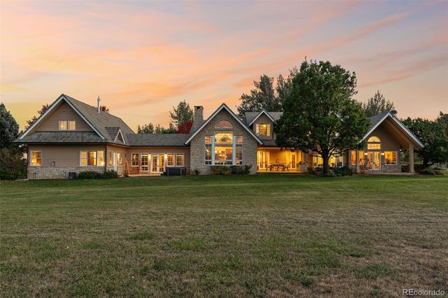 a front view of a house with a yard and trees