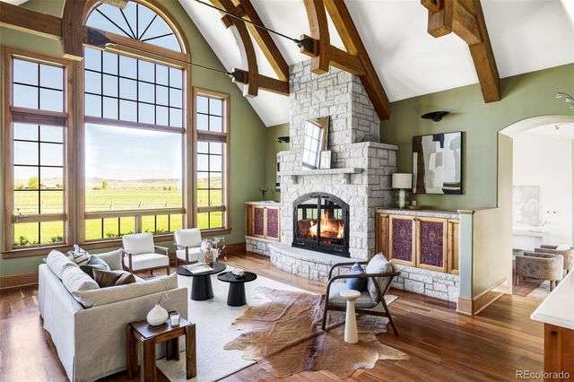 a living room with fireplace furniture and a floor to ceiling window