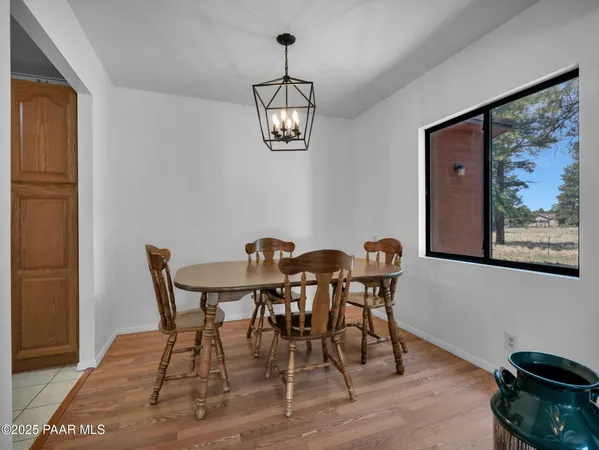 a view of a dining room with furniture wooden floor and a rug