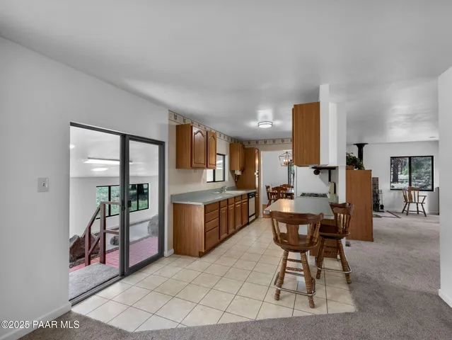 a kitchen with a table chairs refrigerator and a sink