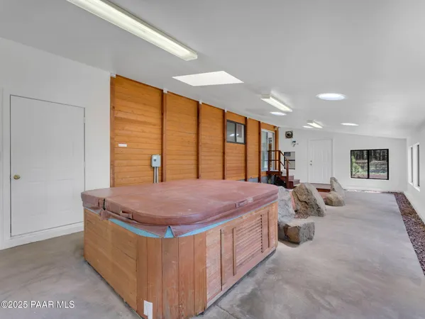 a spacious bedroom with a bed and dresser