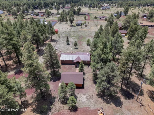 an aerial view of a house with a yard