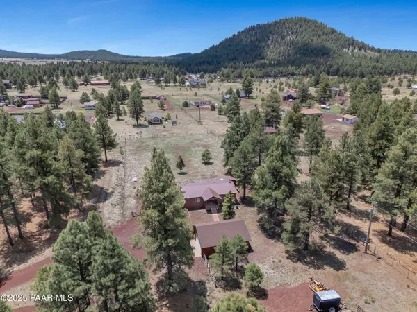 an aerial view of residential house and sandy dunes
