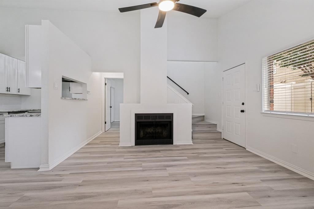 2240 Tarpley Road, Unit 92 Carrollton, TX 75006 - Photo 9 of 22 a view of a livingroom with wooden floor a ceiling fan and windows
