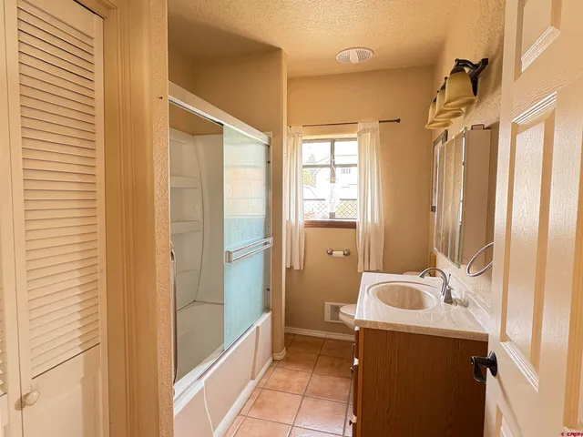 a bedroom with a bed and a table