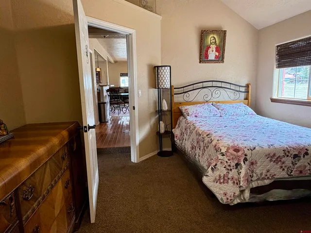 a bedroom with a bed and with a wall painting