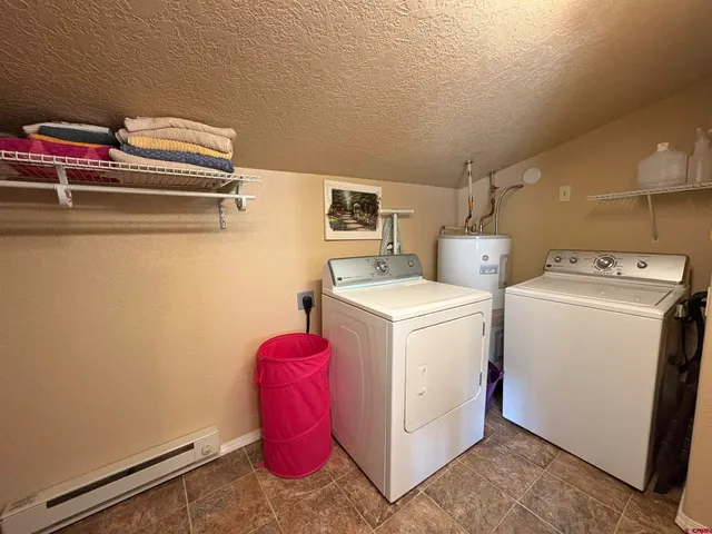 a bedroom with a bed and a mirror on dresser