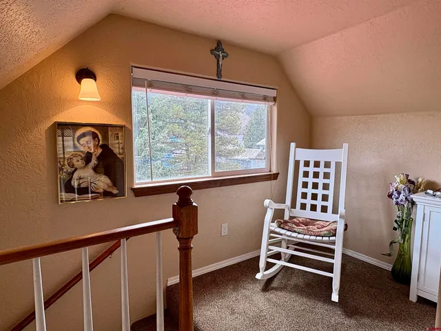a view of a hallway with couch and windows