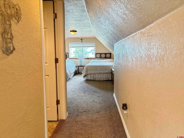 a bathroom with a granite countertop toilet and a sink