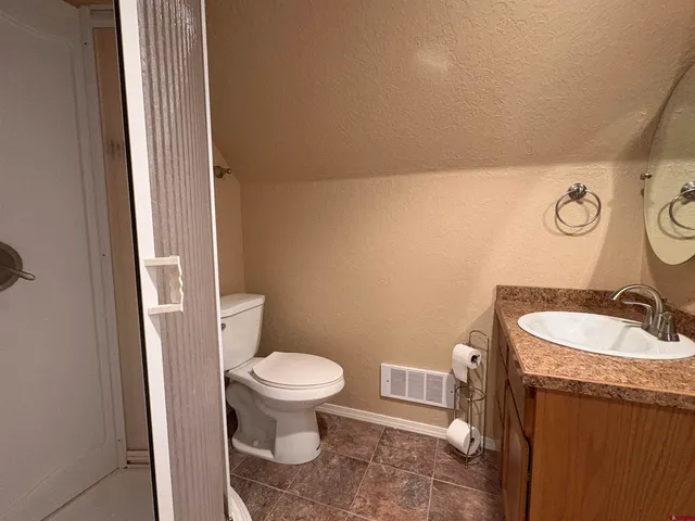 a spacious bedroom with two beds and a large window