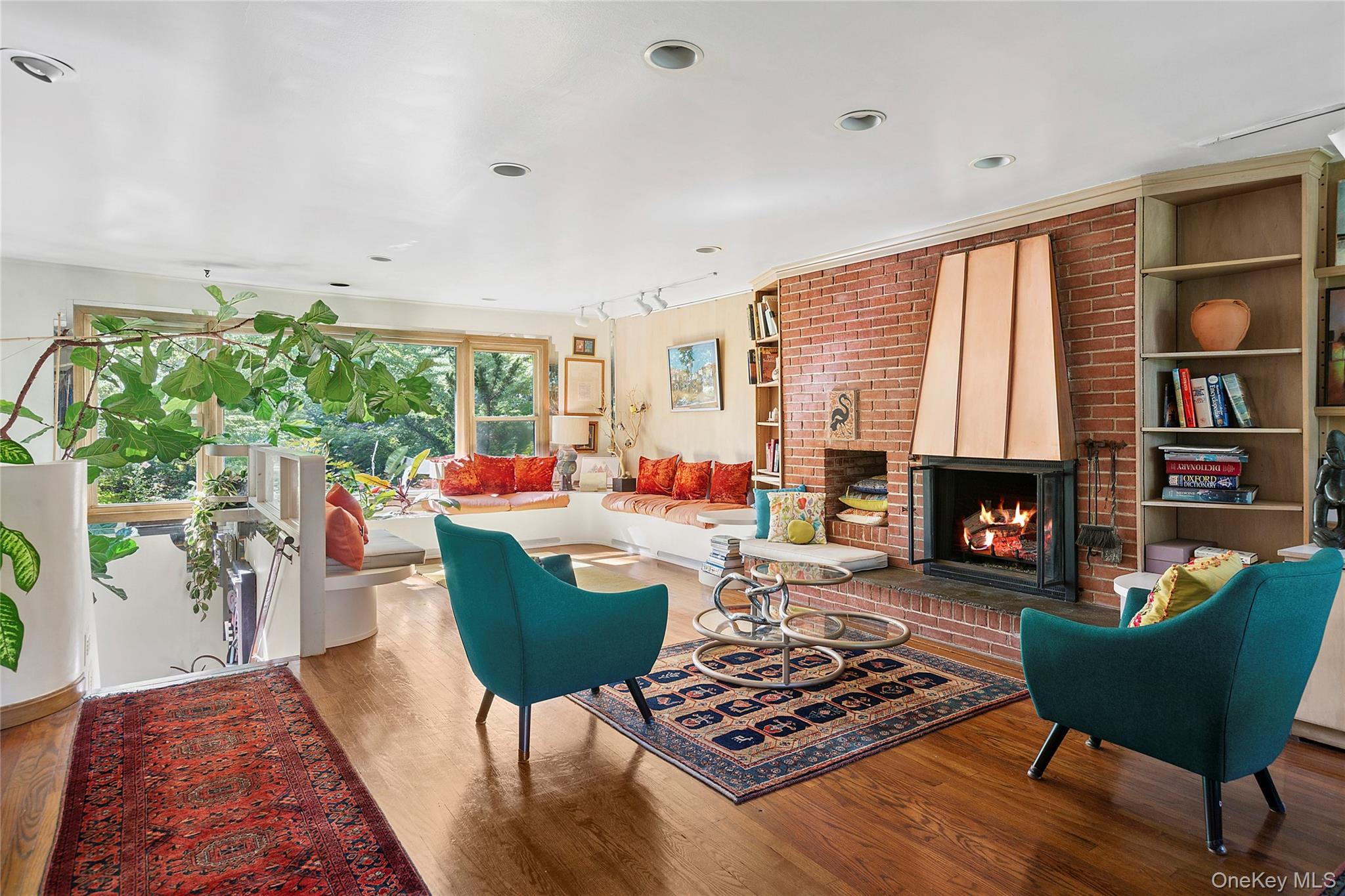 3700 Haywaters Road Cutchogue, NY 11935 - Photo 5 of 22 Living room featuring wood finished floors, a fireplace, and built in shelves