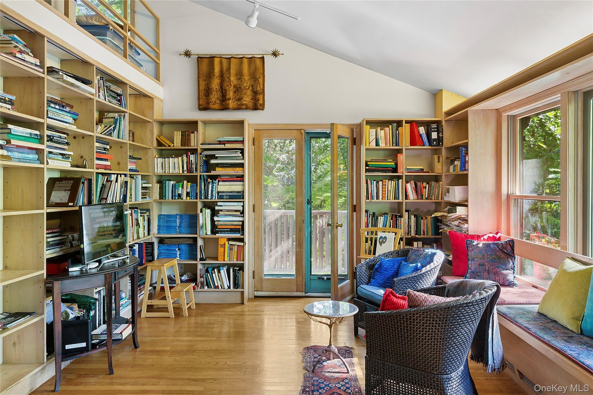 3700 Haywaters Road Cutchogue, NY 11935 - Photo 9 of 22 Living area with light wood-style flooring, lofted ceiling, bookshelves, and track lighting