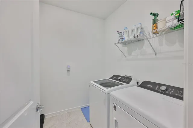 an aerial view of a house with a yard basket ball court and outdoor seating