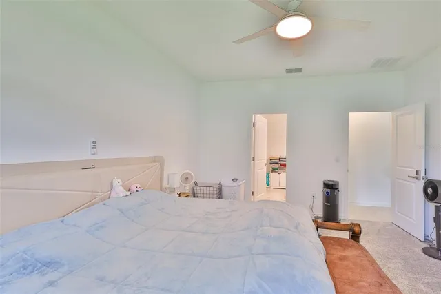 a bedroom with a bed and a lamp