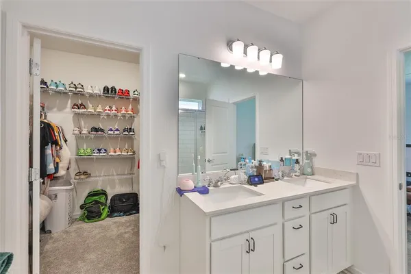 a bathroom with a sink double vanity and a mirror