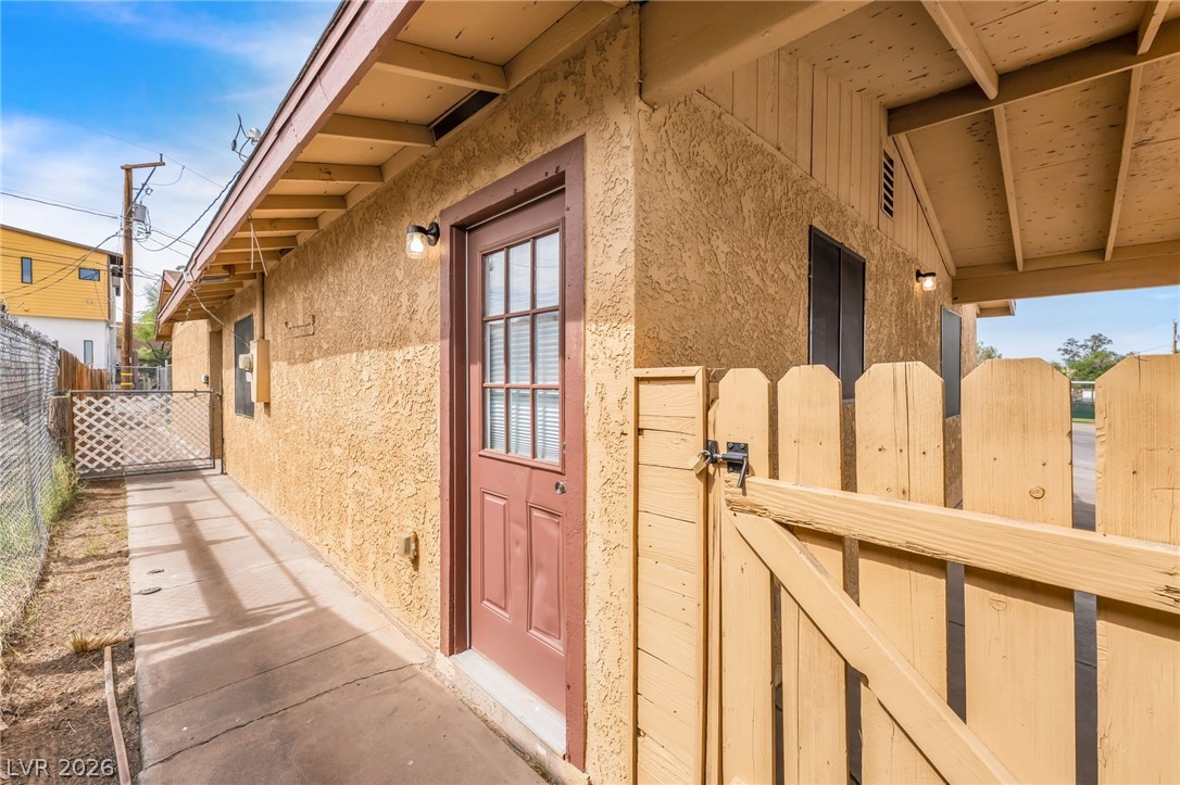 242 Nebraska Avenue Henderson, NV 89015 - Photo 45 of 46 View of side of Unit B with stucco siding and a gate to carport