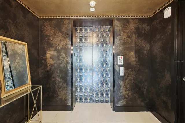 a living room with kitchen island furniture and a flat screen tv