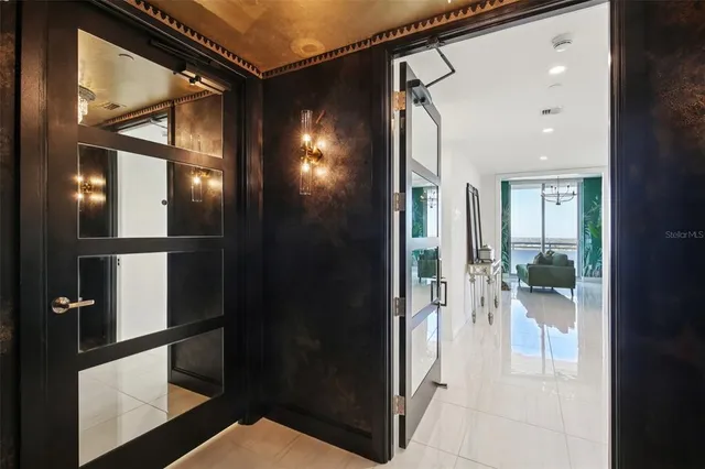 a living room with furniture and kitchen view