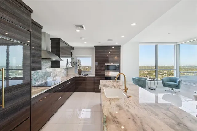 a living room with furniture and floor to ceiling windows
