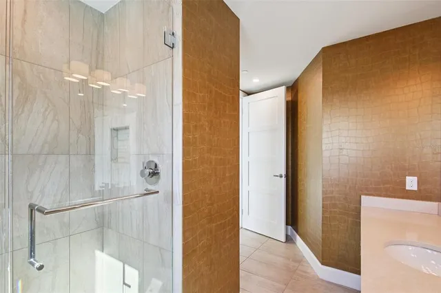 a living room with furniture a chandelier and a large window