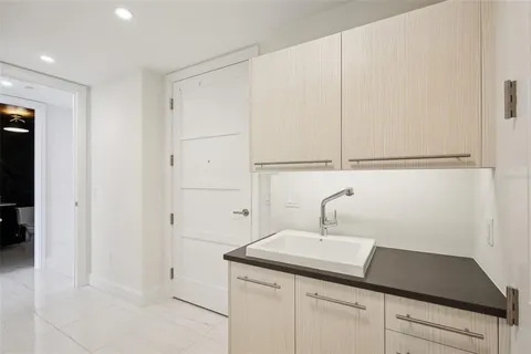 a living room with furniture a chandelier and a large window