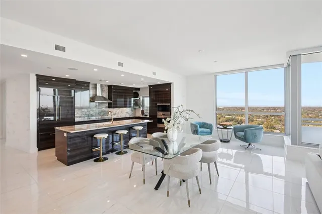 a living room with furniture and kitchen view