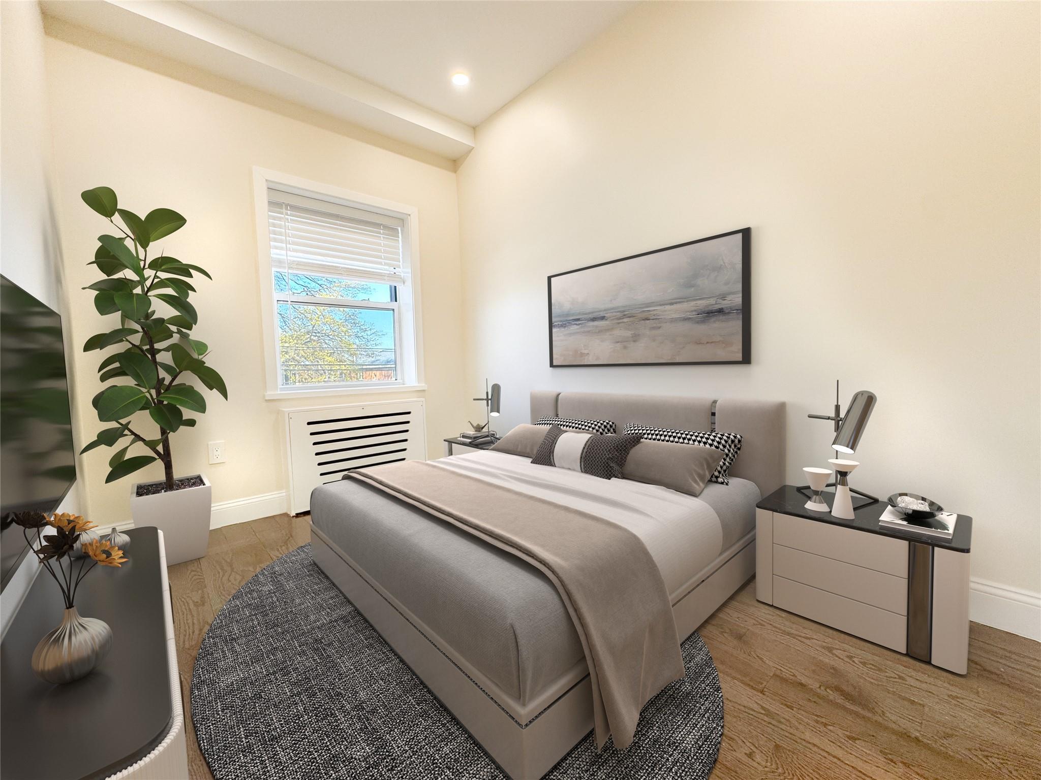 141-14 Booth Memorial Avenue Queens, NY 11355 - Photo 11 of 13 a bedroom with bed and a potted plant