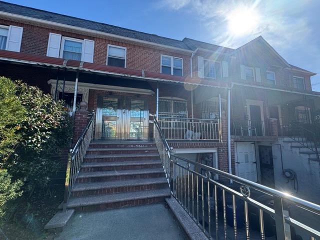 141-14 Booth Memorial Avenue Queens, NY 11355 - Photo 13 of 13 a view of a house with a large window and stairs