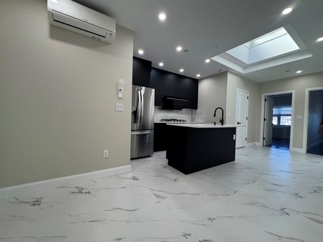 141-14 Booth Memorial Avenue Queens, NY 11355 - Photo 2 of 13 a kitchen with stainless steel appliances a sink and refrigerator