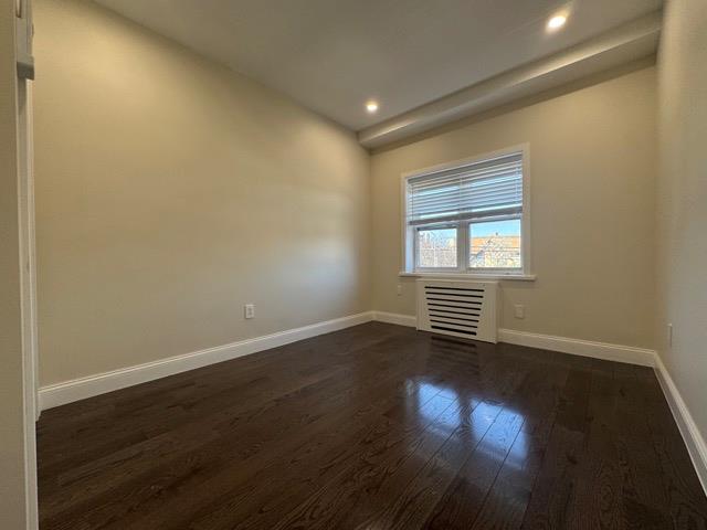 141-14 Booth Memorial Avenue Queens, NY 11355 - Photo 9 of 13 a view of a livingroom with wooden floor and window