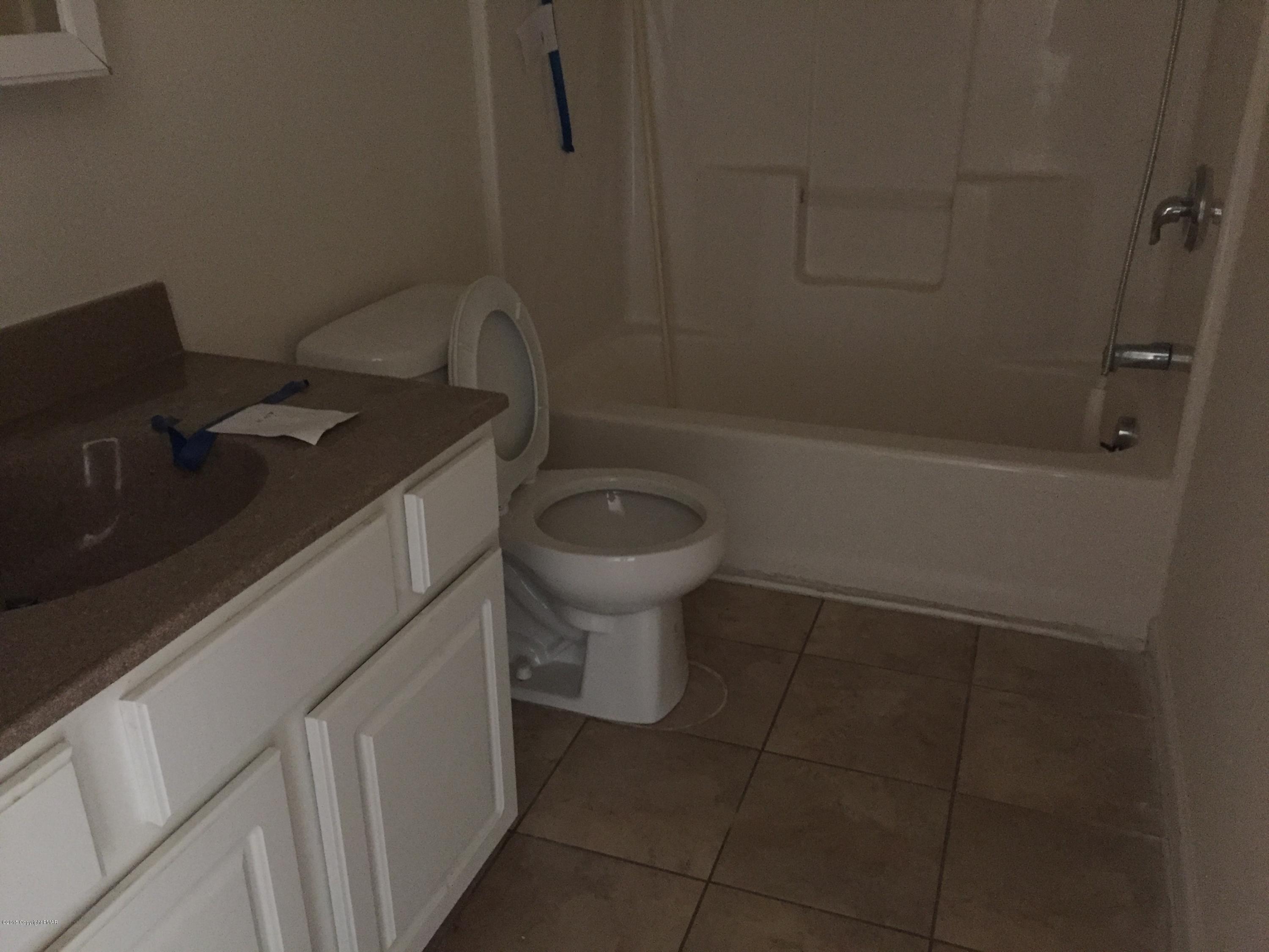 1653 Clover Road North Long Pond, PA 18334 - Photo 6 of 15 a bathroom with a granite countertop toilet and a sink