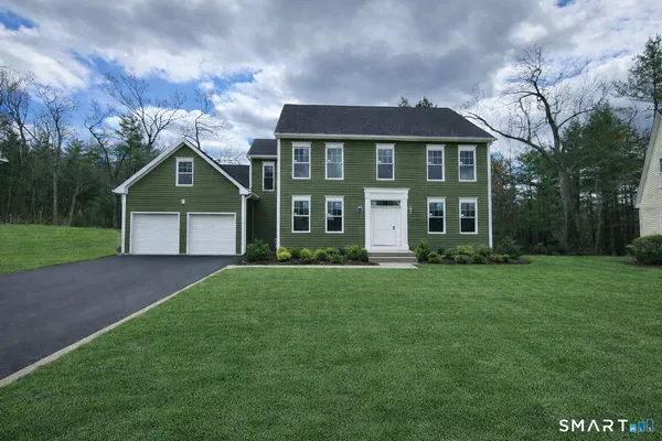 a front view of a house with a yard and garage