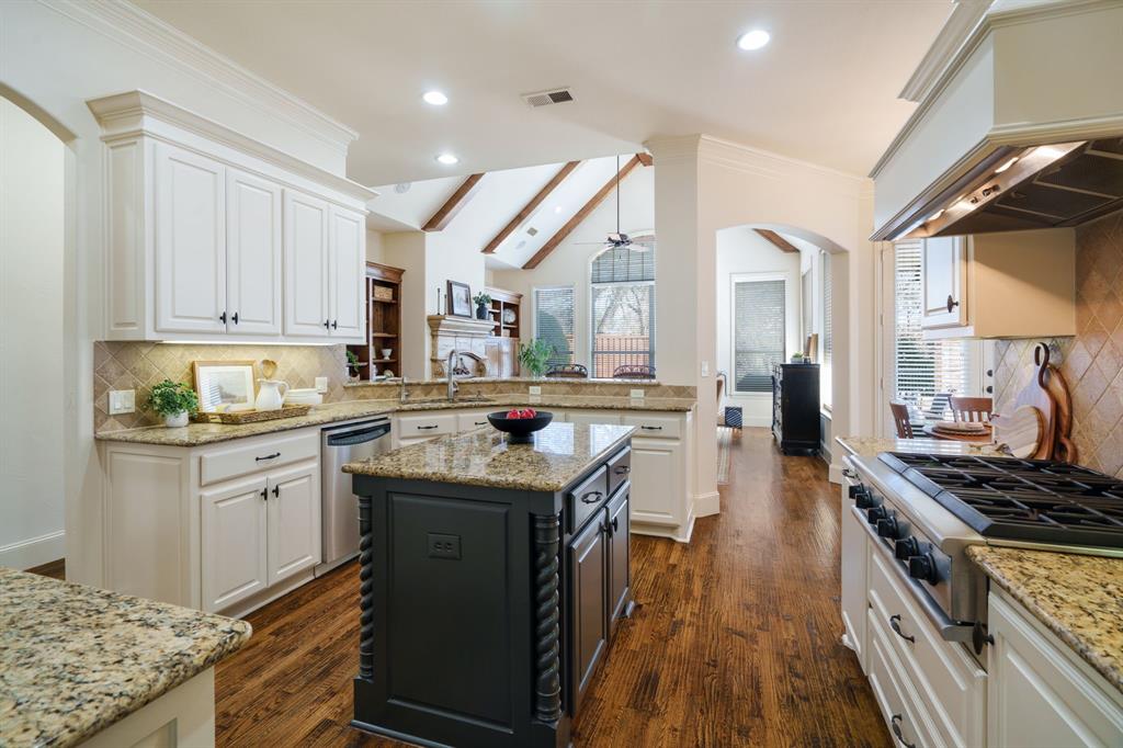 6724 Frankford Road Dallas, TX 75252 - Photo 11 of 40 a kitchen with stainless steel appliances granite countertop a stove and a sink