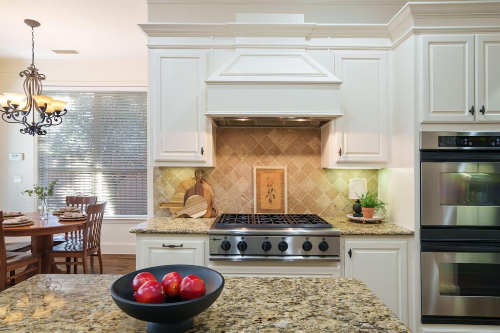 6724 Frankford Road Dallas, TX 75252 - Photo 13 of 40 a kitchen with a stove and cabinets