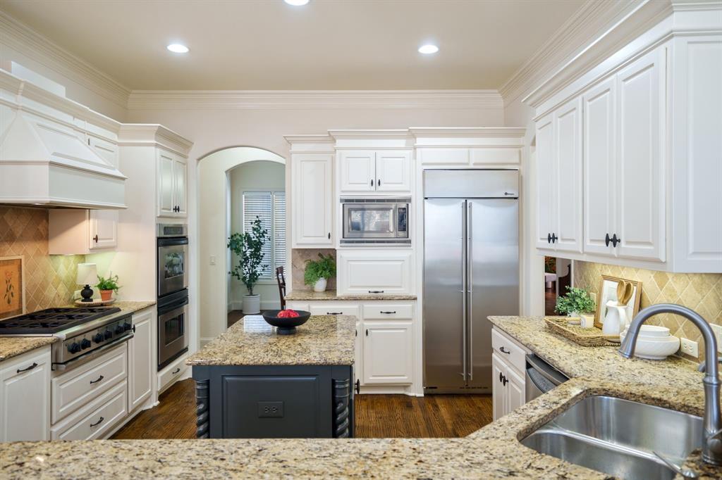 6724 Frankford Road Dallas, TX 75252 - Photo 14 of 40 a kitchen with stainless steel appliances granite countertop a refrigerator a stove top oven and sink