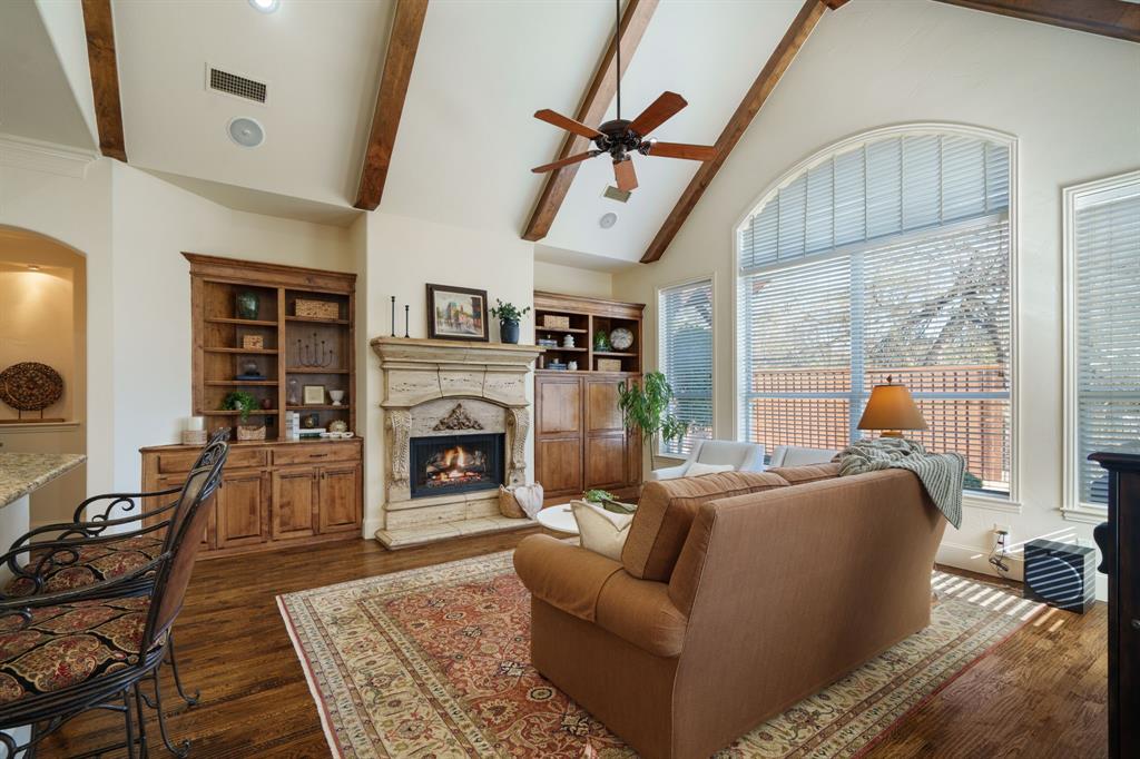 6724 Frankford Road Dallas, TX 75252 - Photo 2 of 40 a living room with furniture a fireplace and a floor to ceiling window