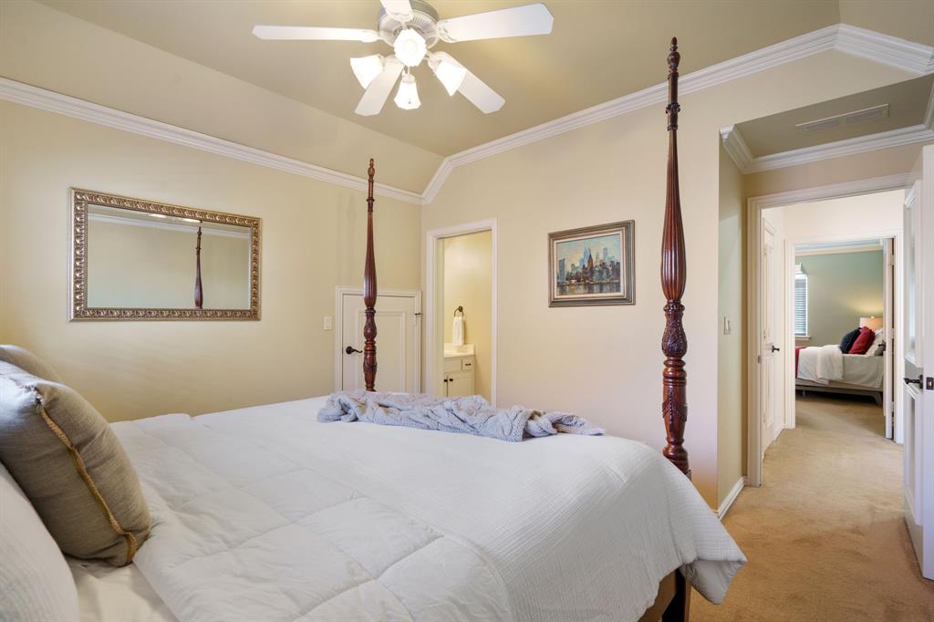6724 Frankford Road Dallas, TX 75252 - Photo 28 of 40 a bedroom with a large bed and a chandelier