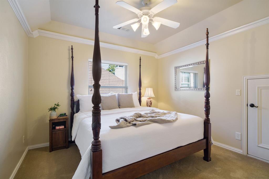 6724 Frankford Road Dallas, TX 75252 - Photo 29 of 40 a bedroom with a bed and a chandelier