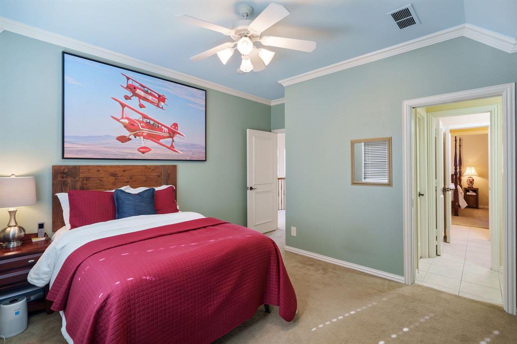6724 Frankford Road Dallas, TX 75252 - Photo 32 of 40 a bed room with a bed and a painting on the wall