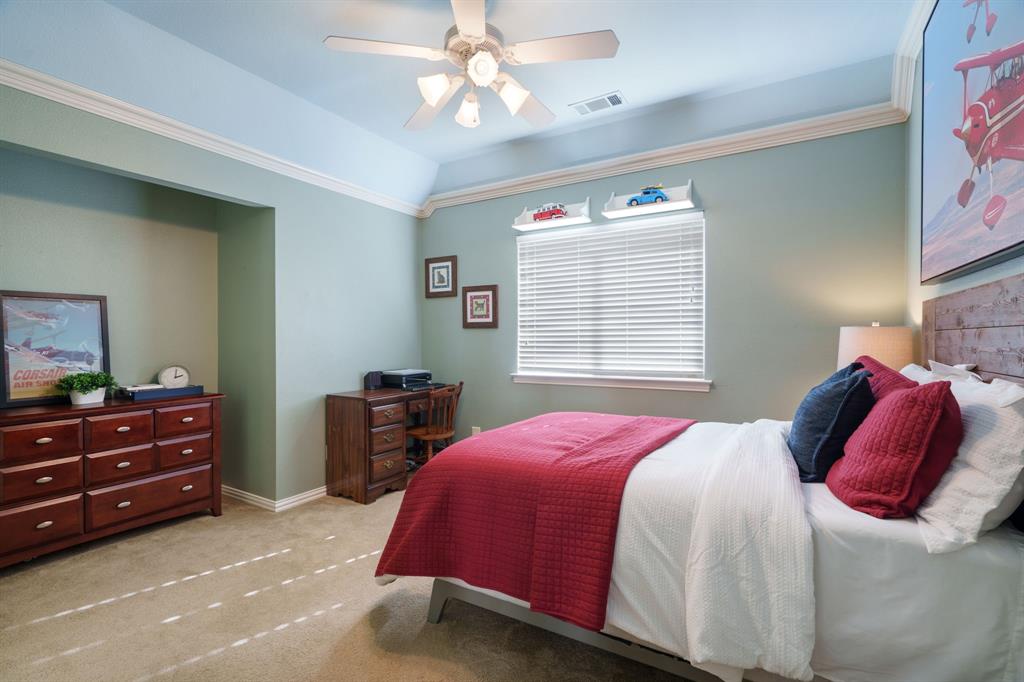6724 Frankford Road Dallas, TX 75252 - Photo 33 of 40 a bedroom with a bed and a chandelier
