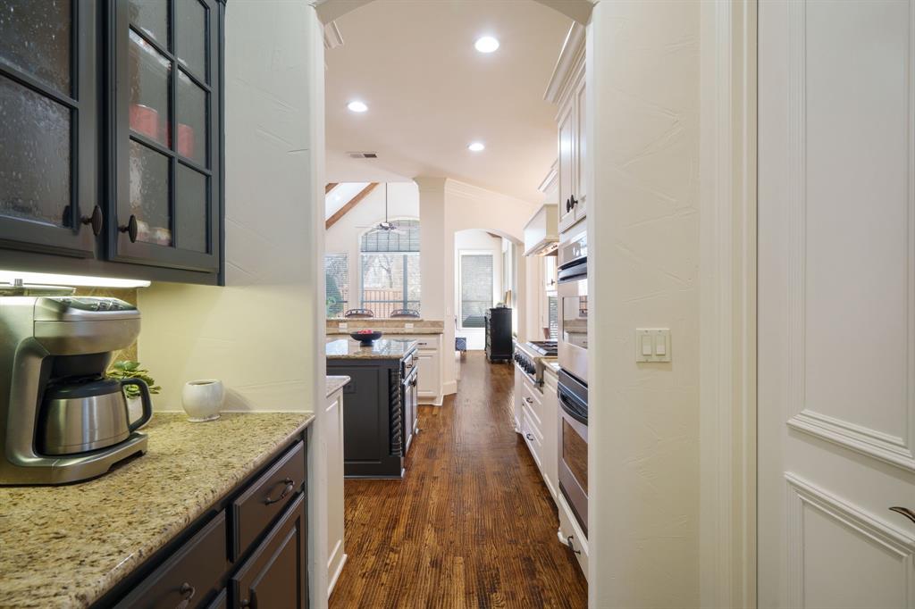 6724 Frankford Road Dallas, TX 75252 - Photo 10 of 40 a kitchen with a sink stove and cabinets