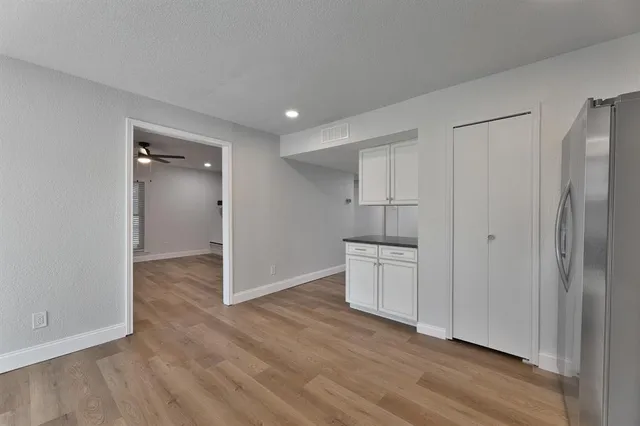 a view of a kitchen with a sink and a refrigerator
