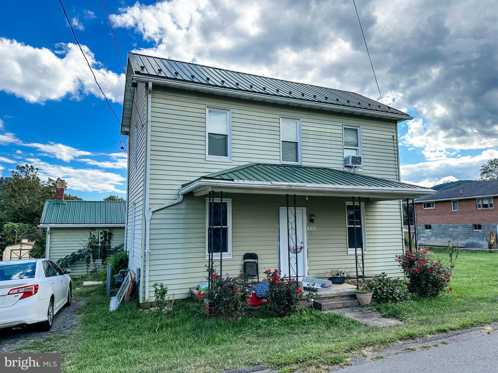 a front view of a house with a garden