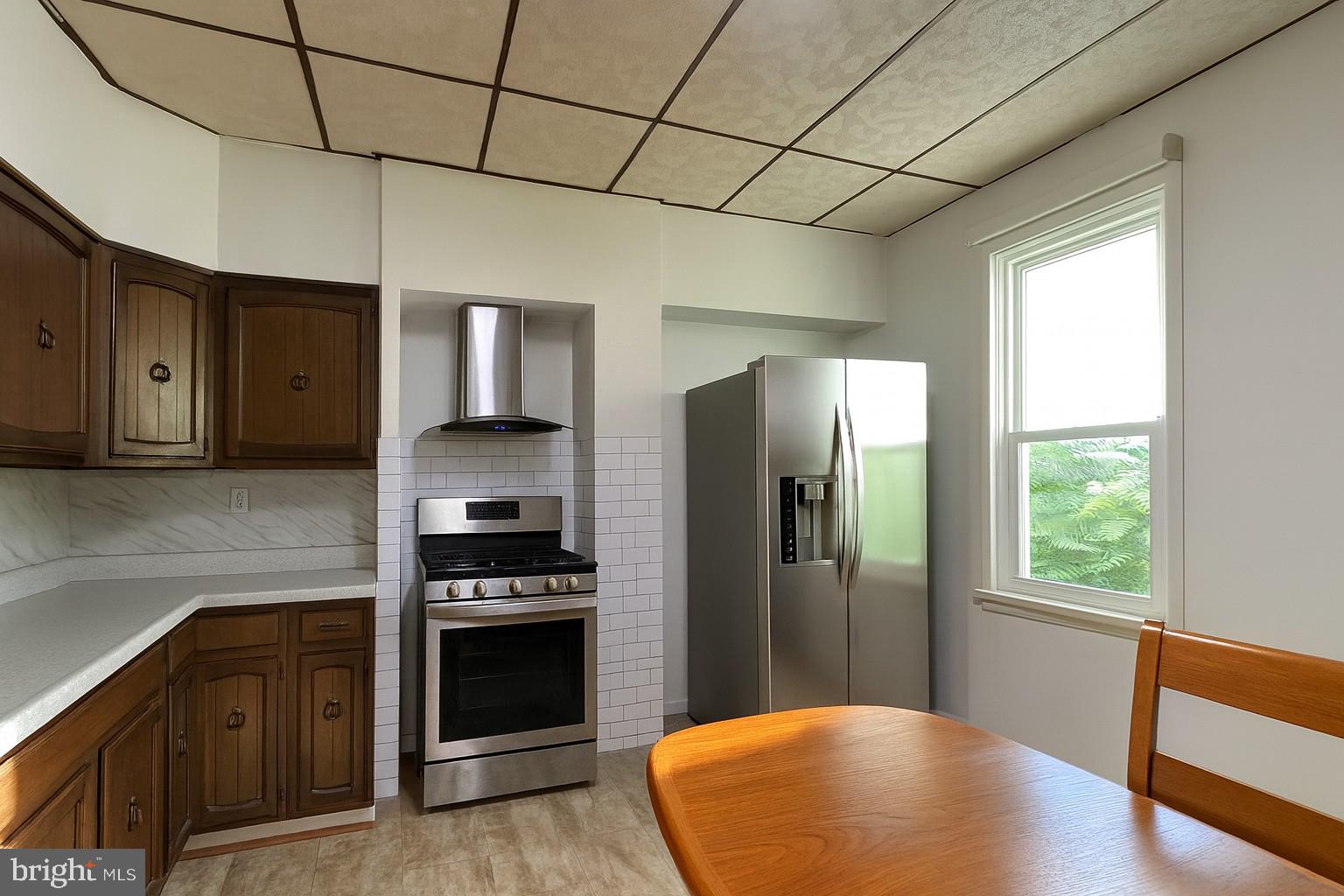 10128 Hummingbird Street Ellerslie, MD 21529 - Photo 7 of 21 a kitchen with stainless steel appliances granite countertop a refrigerator and a sink