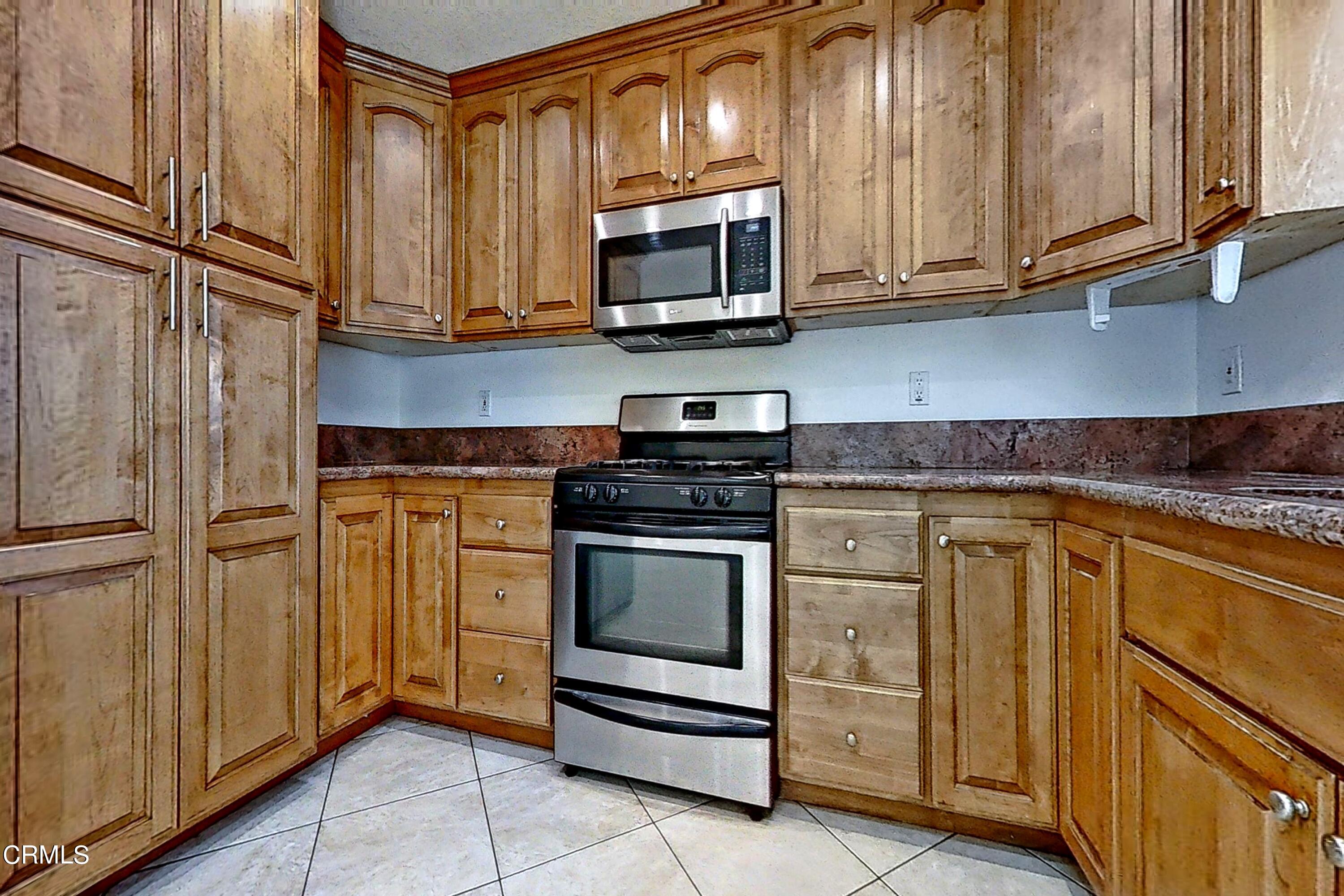 1830 Claremont Drive Oxnard, CA 93035 - Photo 11 of 36 a kitchen with granite countertop cabinets stainless steel appliances and a counter space