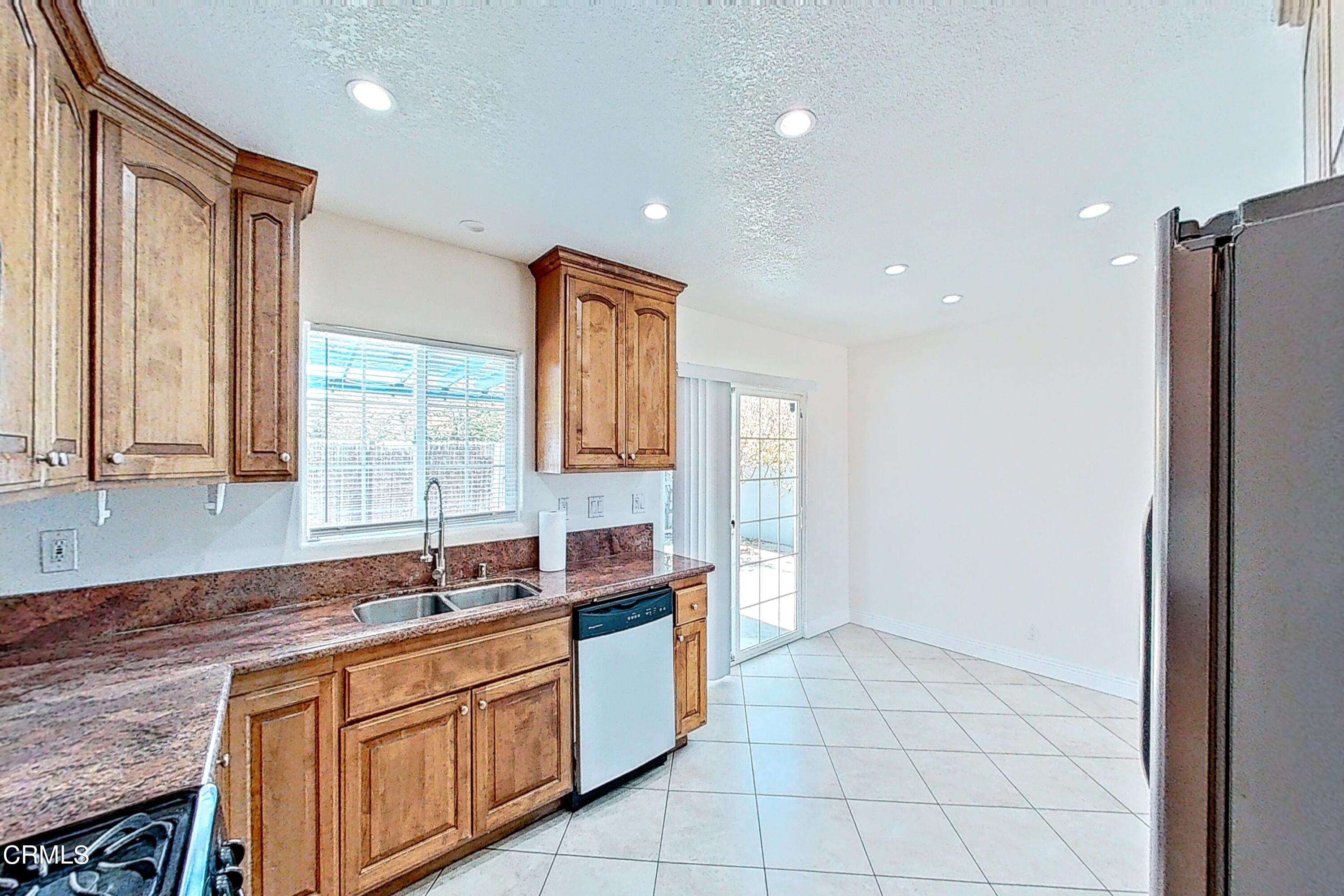 1830 Claremont Drive Oxnard, CA 93035 - Photo 13 of 36 a kitchen with stainless steel appliances granite countertop a sink and a granite counter tops